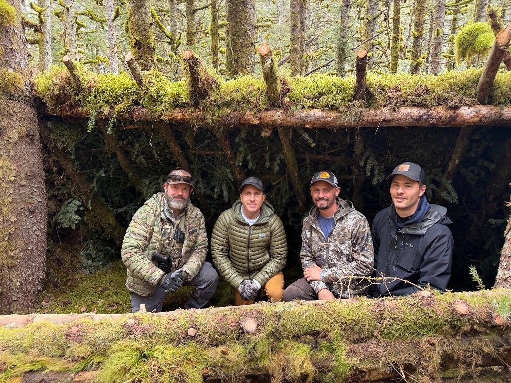Men in a wilderness shelter during survival training